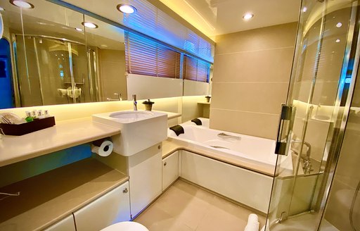 Ensuite with bath and sink in view on superyacht LIONSHARE