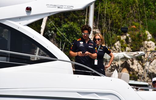 Two guests on a charter yacht geared up for Formula 1 weekend
