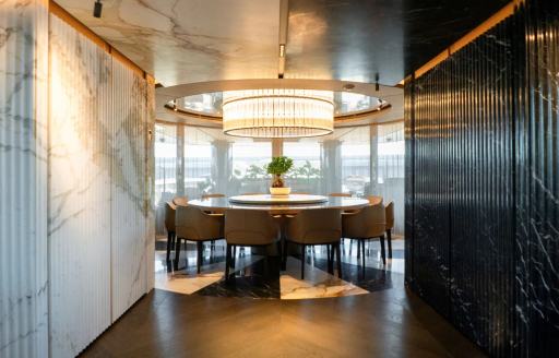 Interiors onboard charter yacht RAJA² with circular table and large windows