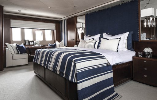 master suite with navy blue and white colour palette and rich wooden panelling on board charter yacht CRISTOBAL 