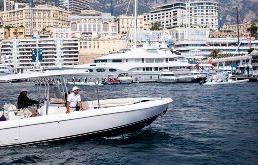 tender zips across Port Hercules during the Monaco Yacht Show