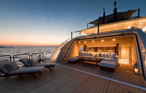 Beach club on superyacht SAMURAI, with sun loungers laid out on swim platform