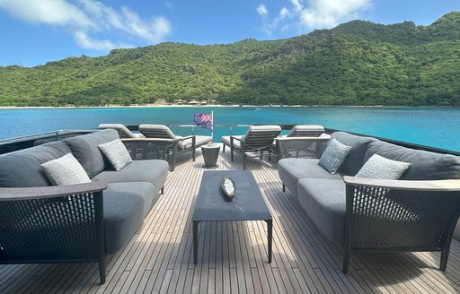 Charter yacht NOI exterior seating area with gray sofas