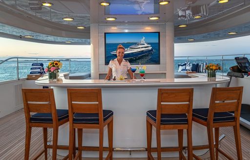 Super yacht charter PISCES exterior wet bar and crew member