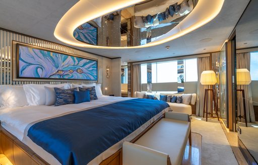 Master cabin onboard charter yacht ETERNAL SPARK with central berth and large window in the background