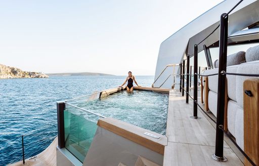 Charter yacht THIS IS IT deck Jacuzzi with charter guest