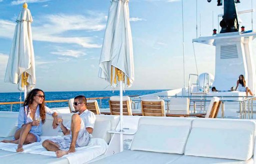 Couple on white sun deck of Illusion I yacht