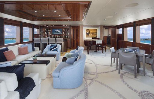 seating area, games table, bar and piano in the skylounge aboard luxury yacht Time For Us 