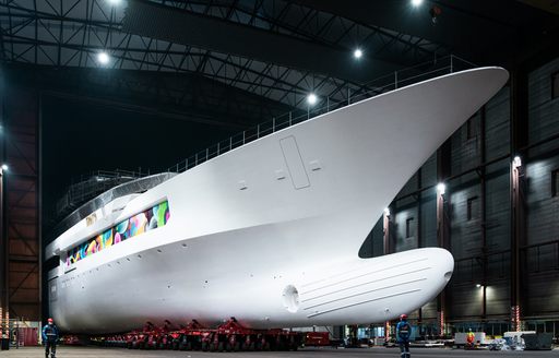 Superyacht DreAMBoat in construction shed with exterior artwork