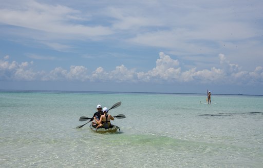 women kayaking around the shallows of thanda island