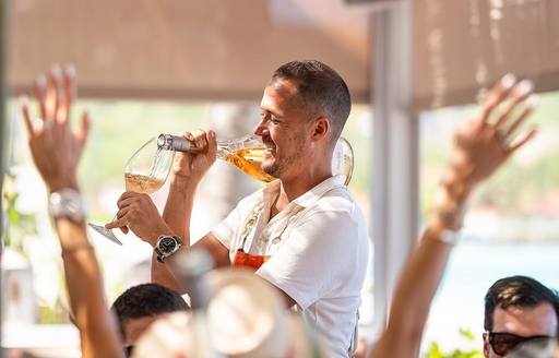 Waiter serving wine at Nao Beach