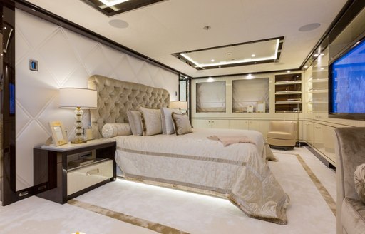 opulent master suite with white furnishings on board motor yacht ELIXIR 