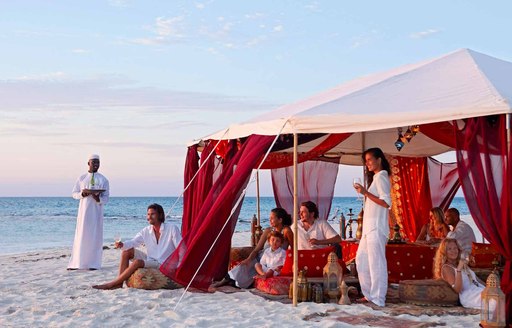 people dining in tent on the beach on thanda island