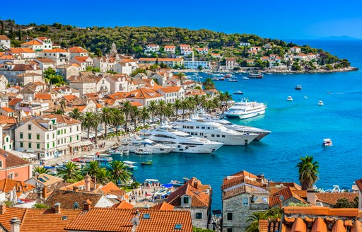 Elevated view looking down on the marina in Hvar, Croatia, with multiple superyacht charters berthed