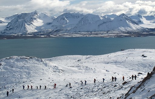 snowy terrains in norway, with hikers walking across