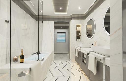 master suite bathroom with large tub and mirroring