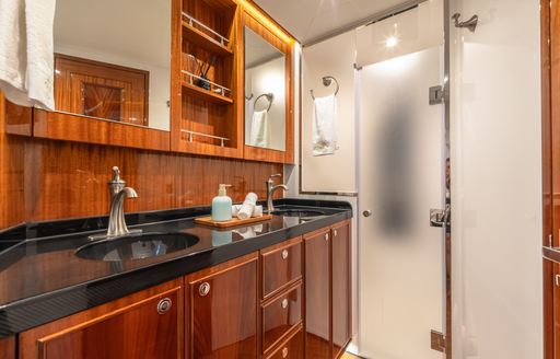 Guest cabin ensuite onboard sailing yacht charter CRAZY LOVE with black sink unit and cubicle