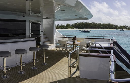 Bar and seating on covered deck of superyacht M3