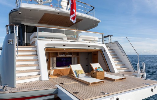 Overview of the beach club onboard charter yacht MANA I, two sun loungers on a swim platform