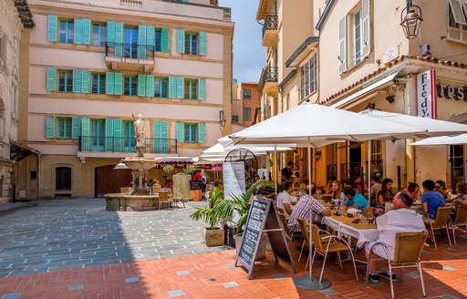 People sat outside around tables in Monaco square