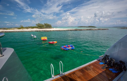 Inflatable toys on board luxury yacht DREAM with views of sandbar in Tahiti