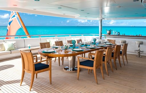 Exterior dining table onboard superyacht charter TITANIA