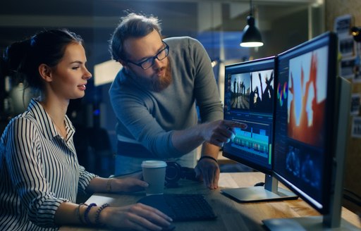 Man and woman use video editing suite