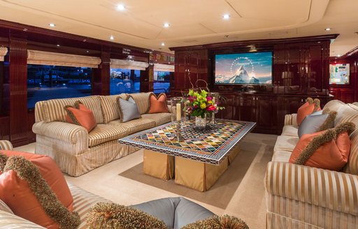 main salon with plush sofas and TV on board motor yacht Lady Joy