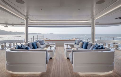 Exterior seating area onboard superyacht charter MALIA, two U-shaped sofas facing each other