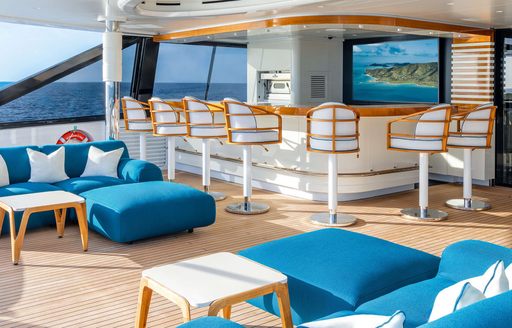 Superyacht charter AMOR A VIDA exterior deck space with wet bar and seating