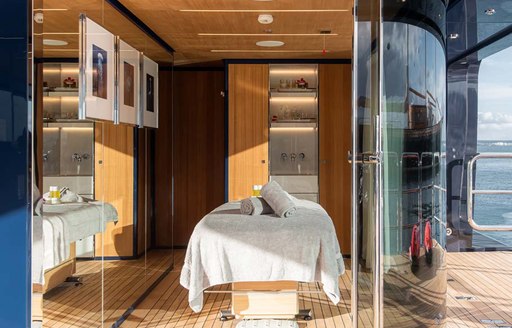 Overview of the massage room onboard Charter yacht RESILIENCE with a centered massage table