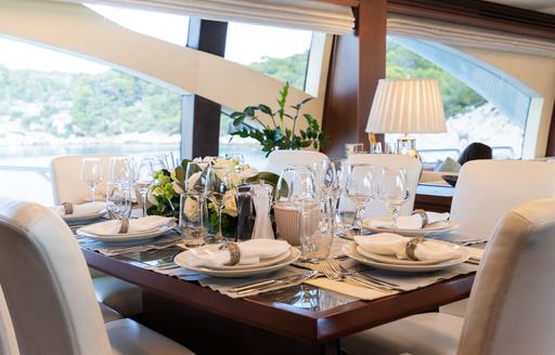Charter yacht KOUKLES interior dining table laid for meal