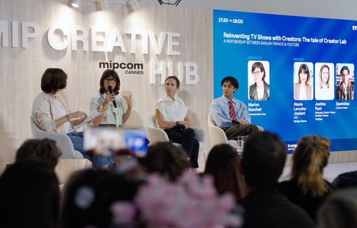 Panel of speakers on stage during MIPCOM seminar