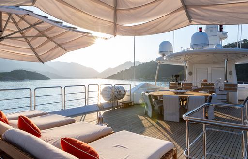 Sun deck with sun loungers and alfresco dining layout onboard charter yacht LADY I 