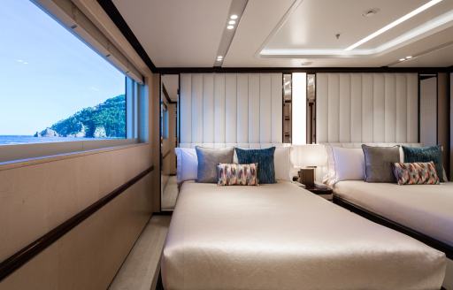 Twin guest cabin onboard charter yacht LADY A with wide window