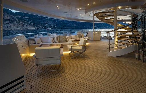 outdoor seating area at dusk on board charter yacht SERENITY 