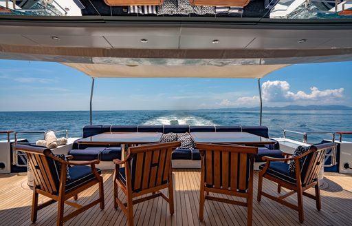 Overview of exteriors onboard charter yacht LADY AZUL. alfresco dining area plus padded chairs