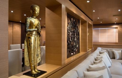 close up of Buddhist statue in main salon of superyacht MISCHIEF 