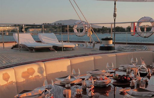 Exterior seating area at sunset, set up for dinner 