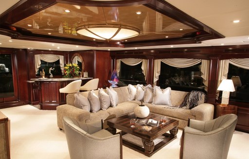 cream sofas in lounge area of main salon on board luxury yacht Claire