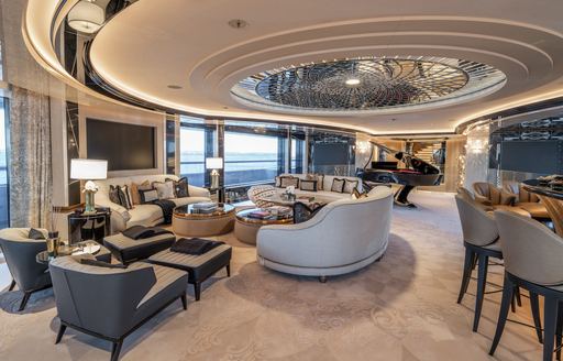 Interiors onboard charter yacht KISMET with plush seating and a grand piano