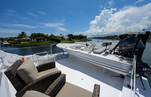 Seating and a tender onboard charter yacht NEXT CHAPTER