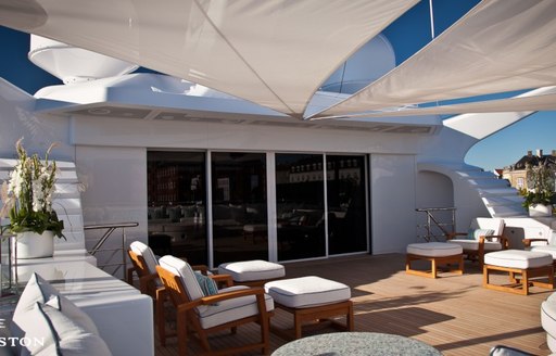 Sun deck with comfortable seats and sun awnings on superyacht Odessa II