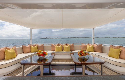 Exterior seating area with sofas and twin tables onboard superyacht charter GIGIA