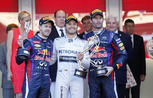 Winners of the Monaco Grand Prix posing with their trophies