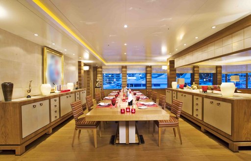 A formal dining table positioned in the centre of an image of the interior of superyacht 'Lady S'