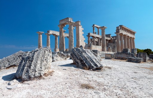 ancient ruins in Greece against backdrop of clear blue skies