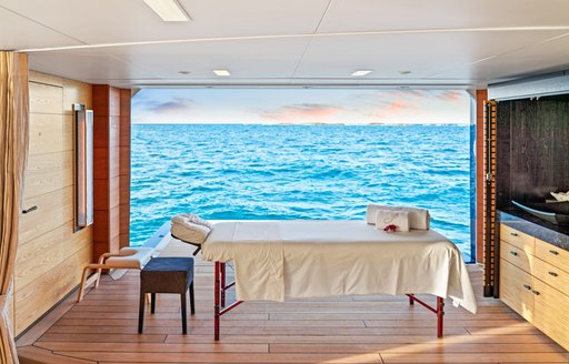 Massage table by open balcony onboard charter yacht AMARYLLIS