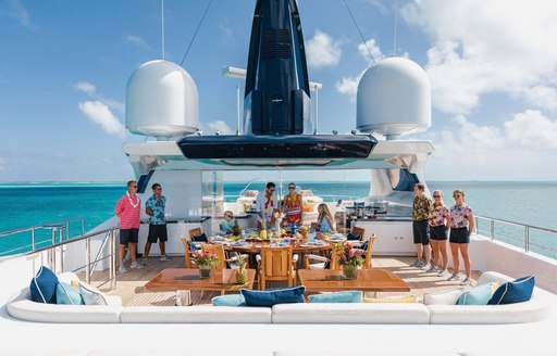 Guests enjoy a Hawaiian themed lunch on board a charter yacht