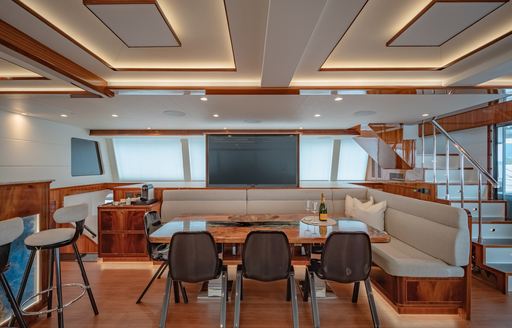 Interior dining area with wet bar adjacent onboard sailing yacht charter CRAZY LOVE